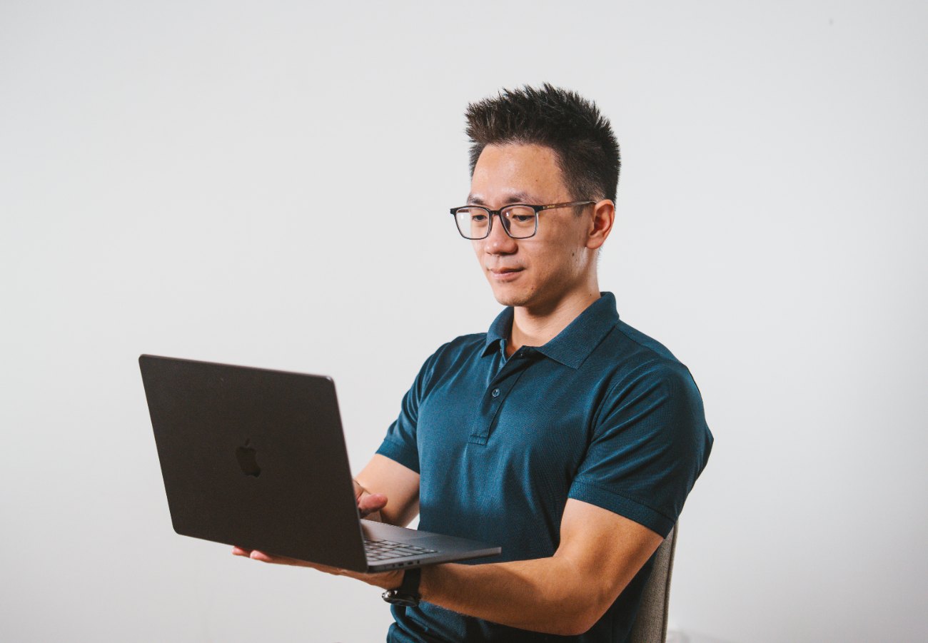 Kuan, working on a laptop
